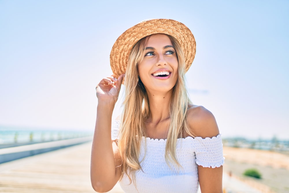 Young blonde tourist girl smiling happy looking to the side